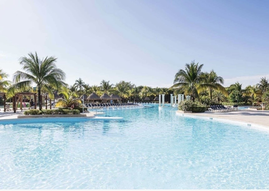 Turquoise infinity pool framed by palms · Your home for 5 days