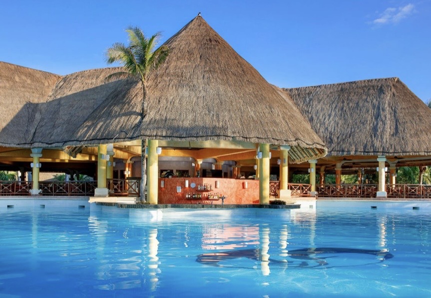Swim-up palapa bar over crystal waters