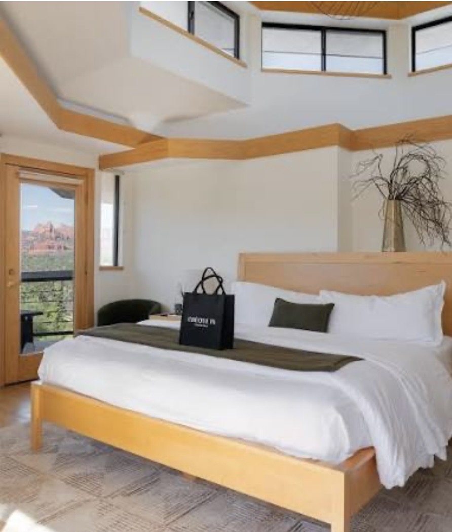 Sun-drenched king suite framing the red rocks
